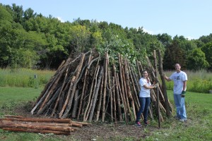 Volunteers with the United Way Day of Caring helping stack logs on the bonfire.