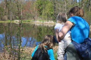 mom-with-daughters-looking-at-pond